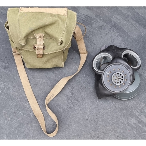 64 - A 1944 British Airborne Troop's lightweight respirator, with anti-gas eye shields, anti-gas ointment... 