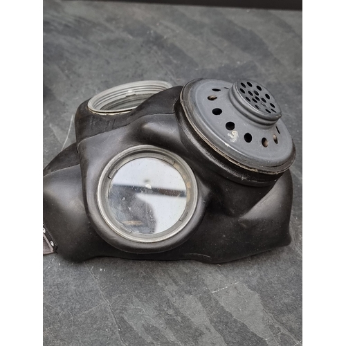 64 - A 1944 British Airborne Troop's lightweight respirator, with anti-gas eye shields, anti-gas ointment... 