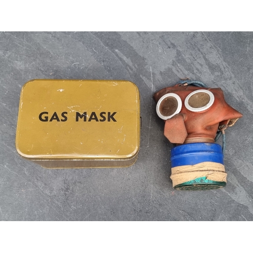 65 - A WWII child's ‘Mickey Mouse' gas mask, in original tin.