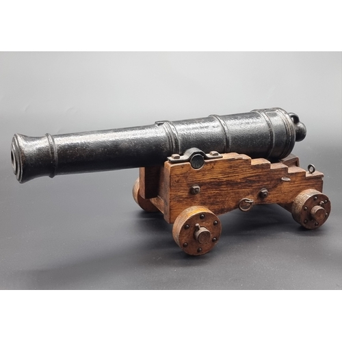 72 - A 19th century cast iron naval cannon model, on four wheel carriage, with 40cm barrel.... 