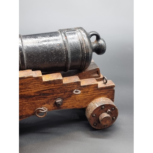 72 - A 19th century cast iron naval cannon model, on four wheel carriage, with 40cm barrel.... 