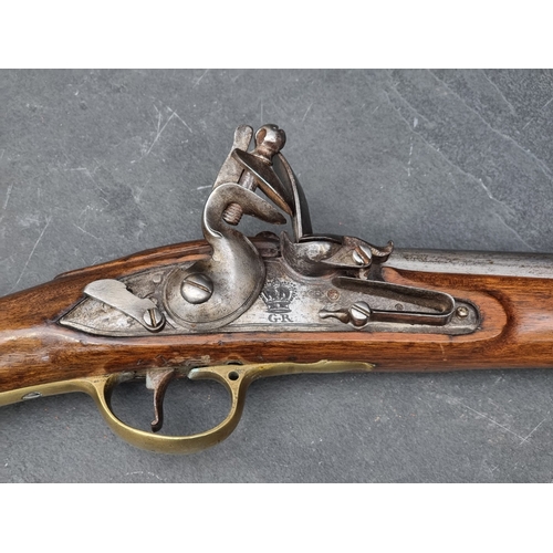 76 - An 18th century flintlock Brown Bess musket, with 101cm barrel and walnut stock, the lock plate stam... 