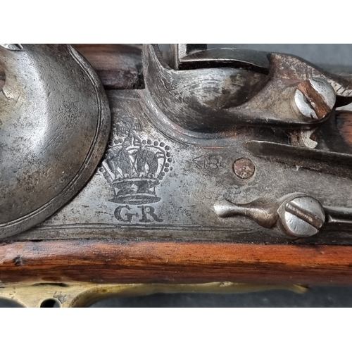 76 - An 18th century flintlock Brown Bess musket, with 101cm barrel and walnut stock, the lock plate stam... 