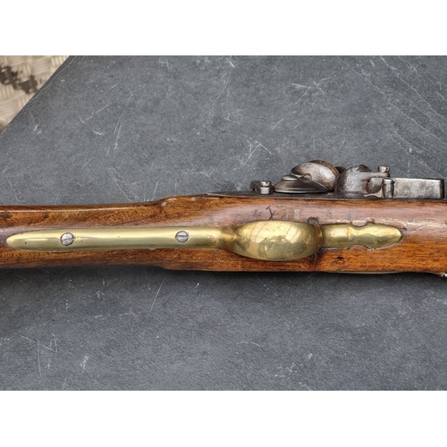 76 - An 18th century flintlock Brown Bess musket, with 101cm barrel and walnut stock, the lock plate stam... 