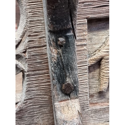 1007 - A 17th century carved oak boarded stool, the frieze carved with fruiting vines and tracery, 53cm wid... 