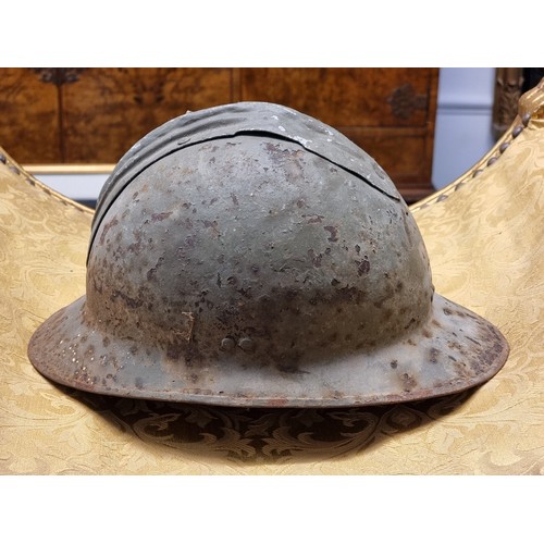 67 - Five various helmets, to include two WWI era French steel examples.