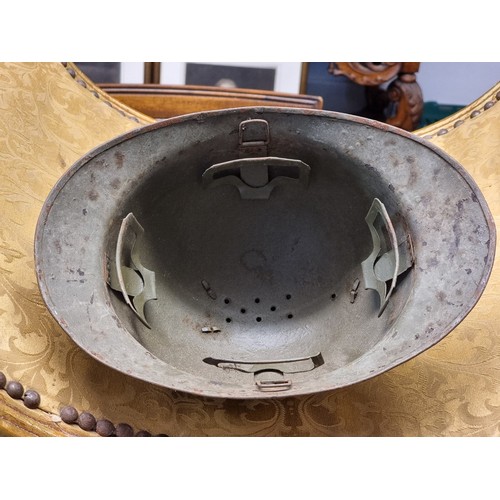 67 - Five various helmets, to include two WWI era French steel examples.