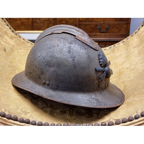 67 - Five various helmets, to include two WWI era French steel examples.