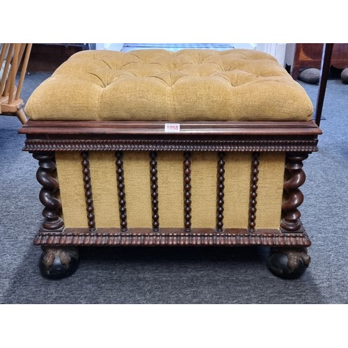 1058 - A Victorian carved rosewood and button upholstered ottoman, on gilt and ebonized ball & claw fee... 