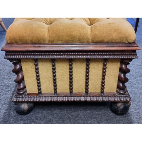 1058 - A Victorian carved rosewood and button upholstered ottoman, on gilt and ebonized ball & claw fee... 