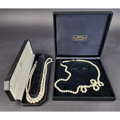 158 - A cultured pearl necklace, having clasp stamped '750', 80cm long; together with another synthetic pe... 