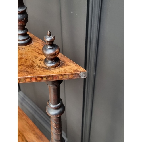 1003 - A Victorian walnut and inlaid four-tier whatnot, 71cm wide.