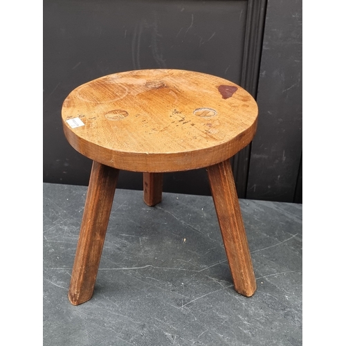 1016 - Two small rustic elm top stools, largest 31cm wide.