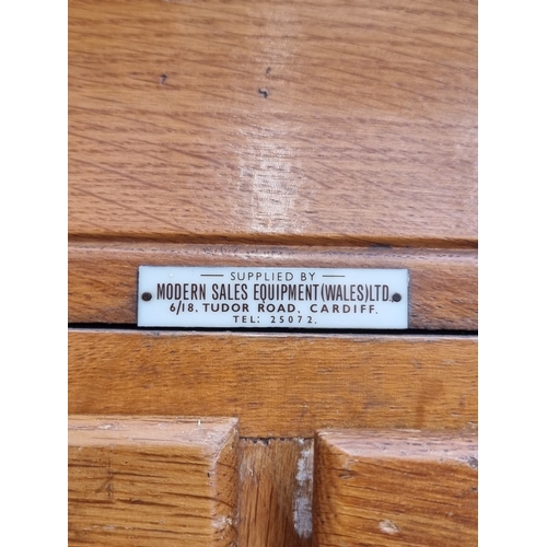 1020 - A mid-century oak multi-drawer haberdashery chest, labelled 'Modern Sales Equipment (Wales) Ltd', 18... 