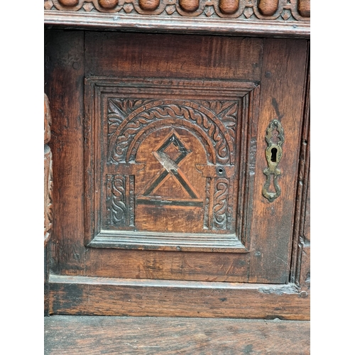 1023 - An antique oak and inlaid buffet, 108cm high x 125cm wide, (probable alterations).