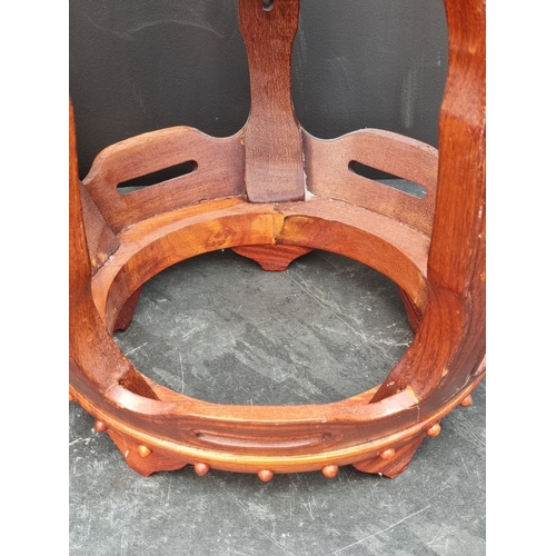 1028 - A pair of Chinese hardwood barrel form stands, 45cm high.