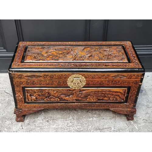 1065 - A small Chinese carved camphor wood coffer, 71cm wide.