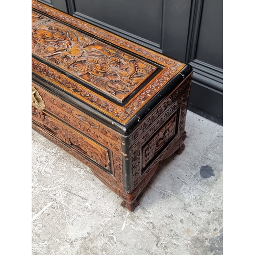 1065 - A small Chinese carved camphor wood coffer, 71cm wide.