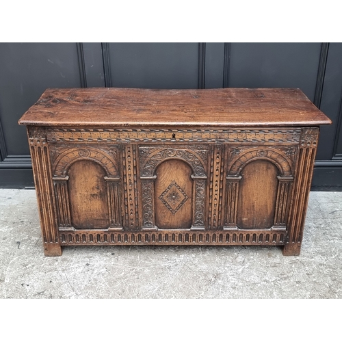 1066 - A 17th century style carved oak panelled coffer, 117.5cm wide.