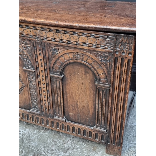 1066 - A 17th century style carved oak panelled coffer, 117.5cm wide.