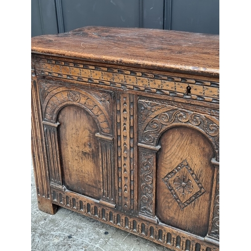 1066 - A 17th century style carved oak panelled coffer, 117.5cm wide.