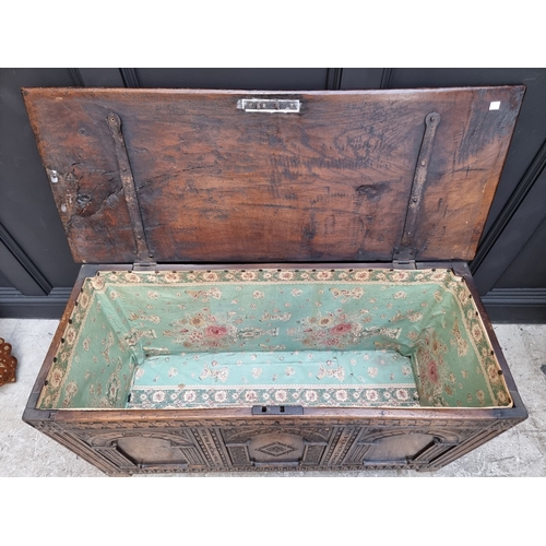 1066 - A 17th century style carved oak panelled coffer, 117.5cm wide.