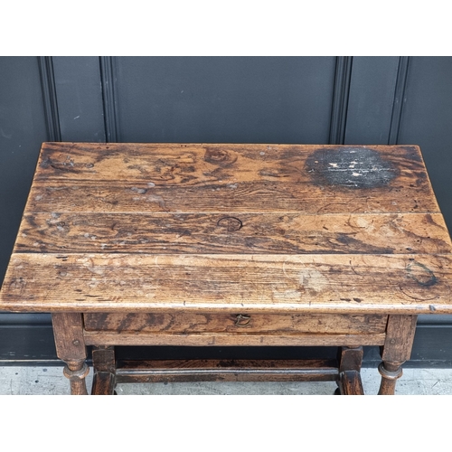 1055 - A late 17th/early 18th century oak single drawer side table, 76cm wide