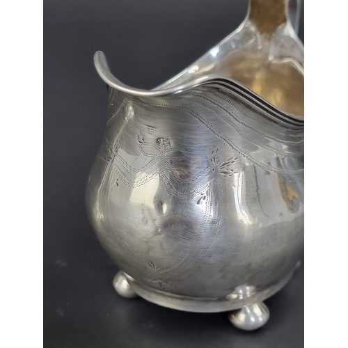 121 - A Georgian silver cream jug, marks rubbed, height to handle 9.5cm; together with a silver trumpet va... 