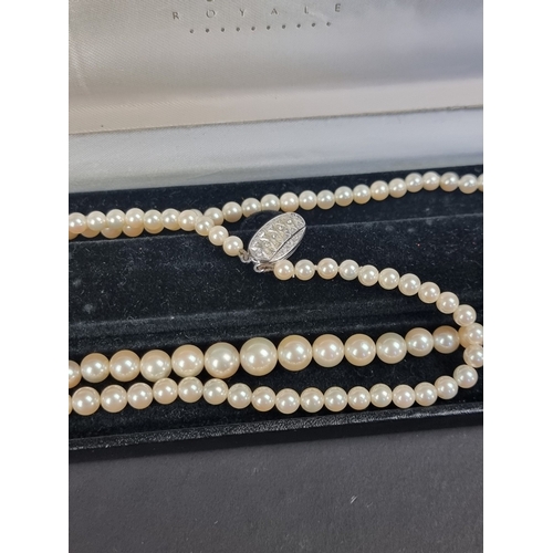 158 - A cultured pearl necklace, having clasp stamped '750', 80cm long; together with another synthetic pe... 