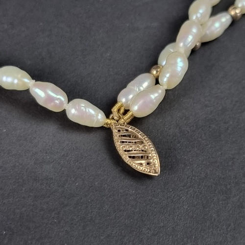 162 - A cased freshwater pearl three strand necklace, clasp stamped '375', 42cm.