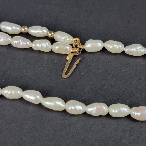 162 - A cased freshwater pearl three strand necklace, clasp stamped '375', 42cm.