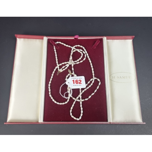 162 - A cased freshwater pearl three strand necklace, clasp stamped '375', 42cm.