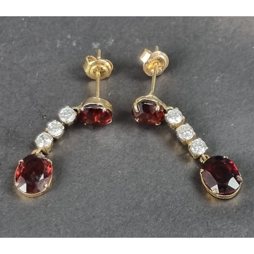 166 - A pair of yellow metal garnet and white gemstone set pendant earrings, 29mm long, in Trevor Towner b... 