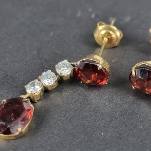 166 - A pair of yellow metal garnet and white gemstone set pendant earrings, 29mm long, in Trevor Towner b... 