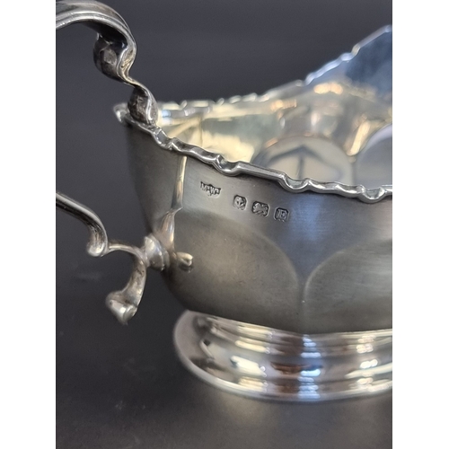 17 - A silver cream jug, by Mappin & Webb Ltd, Birmingham 1929, height to handle 8.5cm, 141g.... 