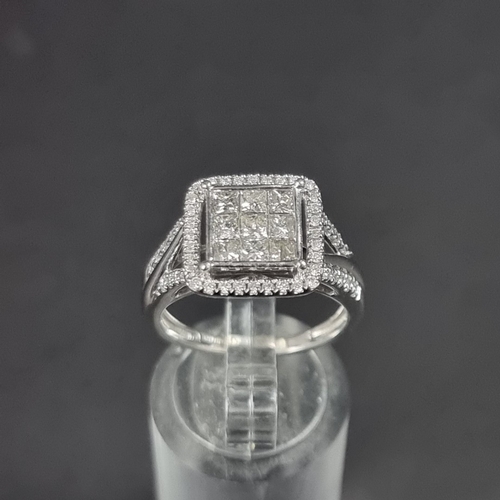 180 - A 9ct white gold diamond ring, pave set to centre with nine square cut diamonds surrounded with a bo... 