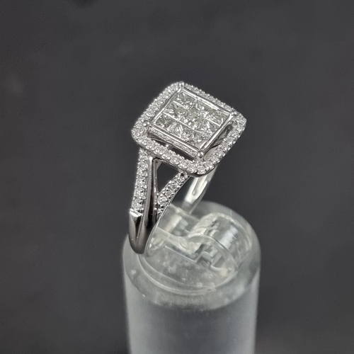 180 - A 9ct white gold diamond ring, pave set to centre with nine square cut diamonds surrounded with a bo... 