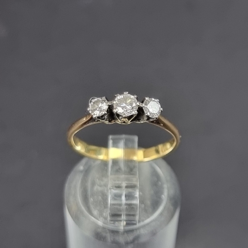 182 - A yellow metal diamond three stone ring, size K 1/2.