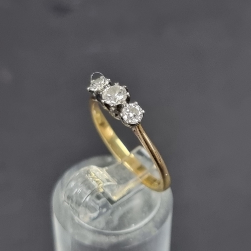 182 - A yellow metal diamond three stone ring, size K 1/2.