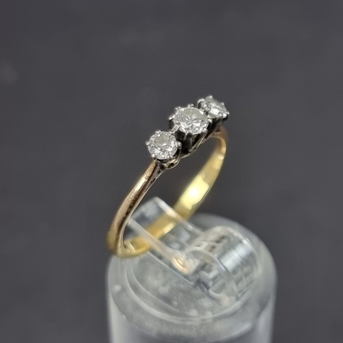 182 - A yellow metal diamond three stone ring, size K 1/2.