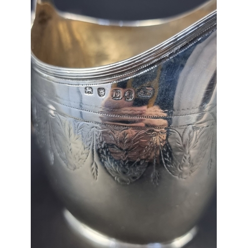 27 - A George III silver milk jug, maker's mark rubbed, Sheffield 1799, height to handle 10.5cm, 101g.... 