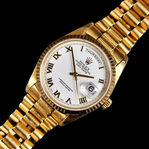 A circa 1990 Rolex 'Day-Date' 18ct gold automatic wristwatch, 36mm, Ref. 18238, case back Ref. 18200, Cal. 3155, Serial No. 5268265, on original 18ct gold 'President' bracelet, clasp stamped '8385', end links stamped '55B', complete with 'buckle' case (Ref. 71.00.03), outer box, cushion insert, 'Datejust' manual, swing tag, card wallet, Chronometer guarantee and two spare links, (dial replaced as part of Rolex service).