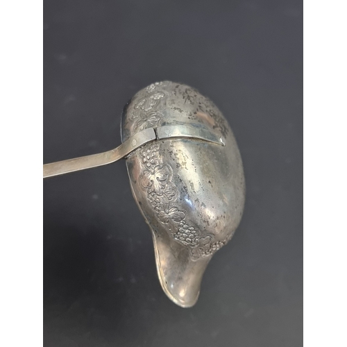 48 - A Georgian white metal and baleen handled toddy ladle.