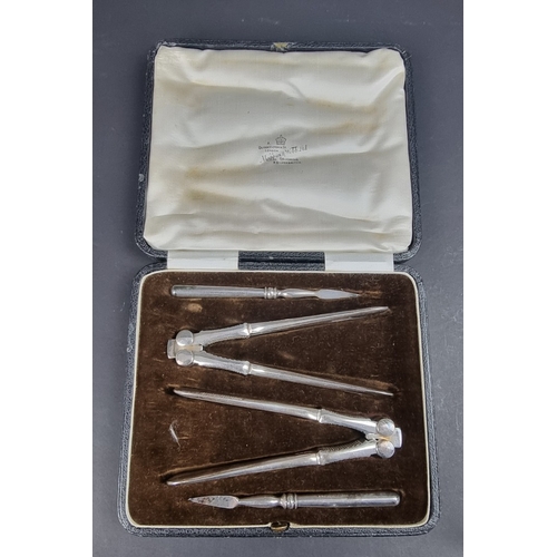 66 - A cased set of two silver plated nutcrackers and matching picks, by Mappin & Webb.... 