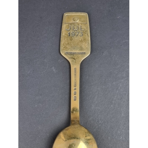 82 - A Danish gilded white metal and enamel Christmas spoon, by A Michelsen, 1973, stamped '925 S'.... 