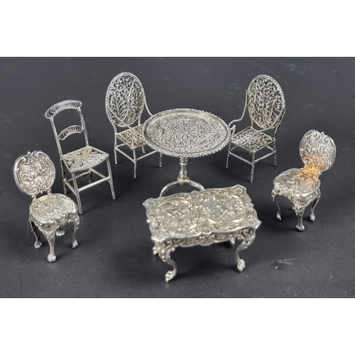 90 - A miniature silver novelty table and pair of chairs, 23g; together with a similar Chinese miniature ... 