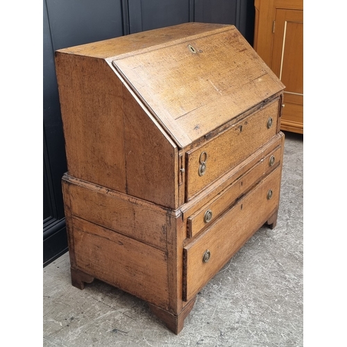 1003 - An 18th century oak bureau, in two parts, 91cm wide, (alterations).