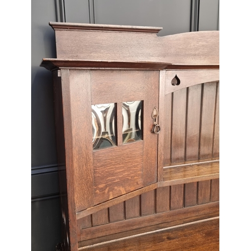 1007 - An interesting Art Nouveau oak side cabinet, in the manner of Liberty, 152.5cm wide.... 