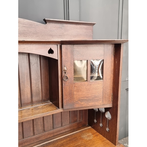 1007 - An interesting Art Nouveau oak side cabinet, in the manner of Liberty, 152.5cm wide.... 