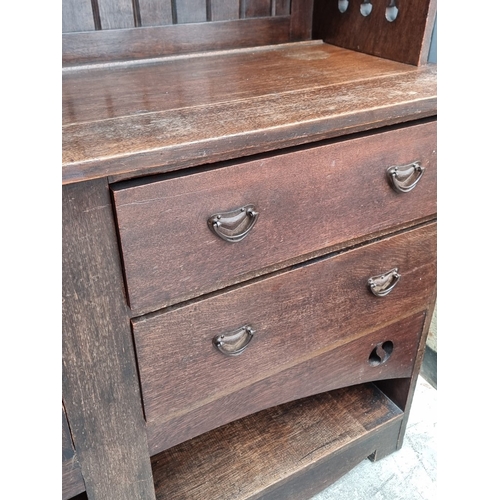 1007 - An interesting Art Nouveau oak side cabinet, in the manner of Liberty, 152.5cm wide.... 